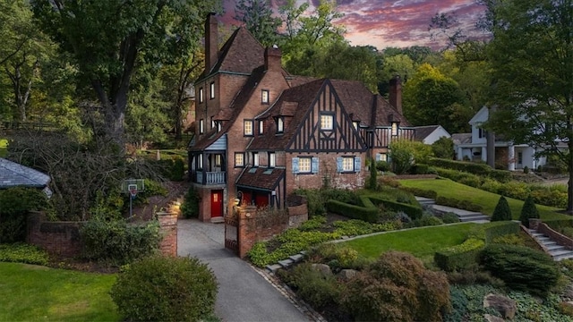 430 Woodland Rd, Edgeworth, PA 15143 - tudor-style house with a chimney and stairway