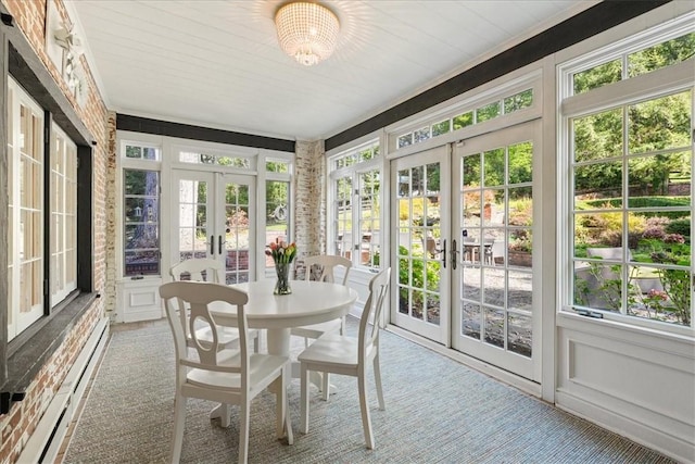 sunroom / solarium featuring french doors and a baseboard heating unit