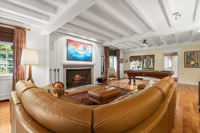 living room with billiards, beamed ceiling, and light wood-type flooring