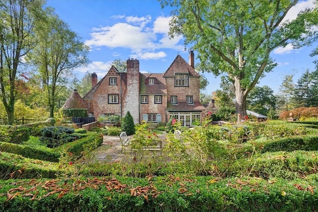 tudor-style house featuring a patio