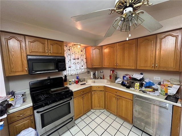 kitchen featuring ceiling fan, stainless steel appliances, and sink