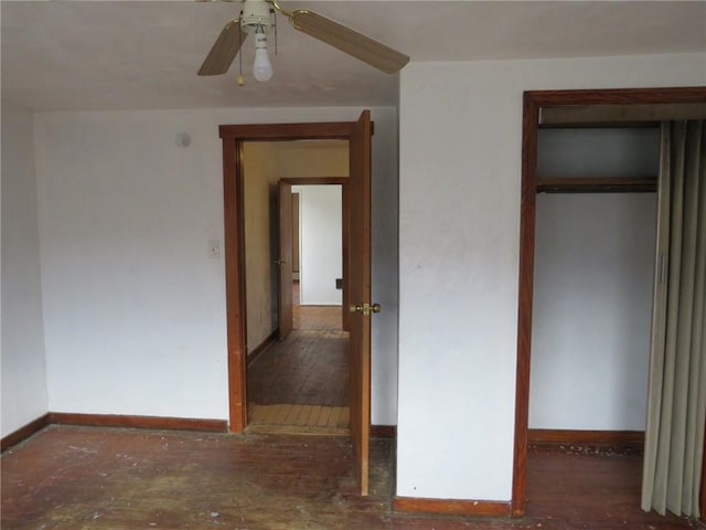 unfurnished bedroom with a ceiling fan, a closet, baseboards, and wood finished floors