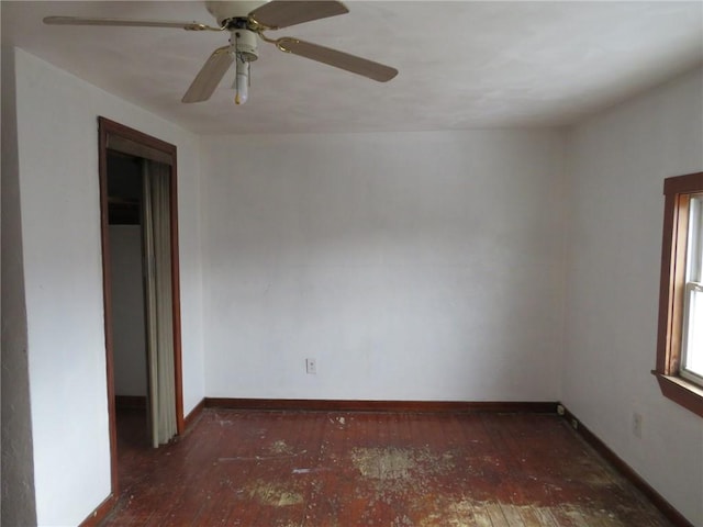 empty room with hardwood / wood-style floors and baseboards