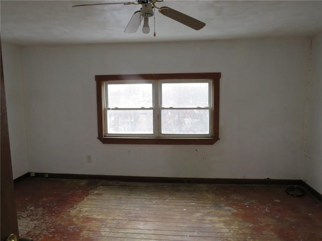 empty room featuring ceiling fan, wood-type flooring, and baseboards