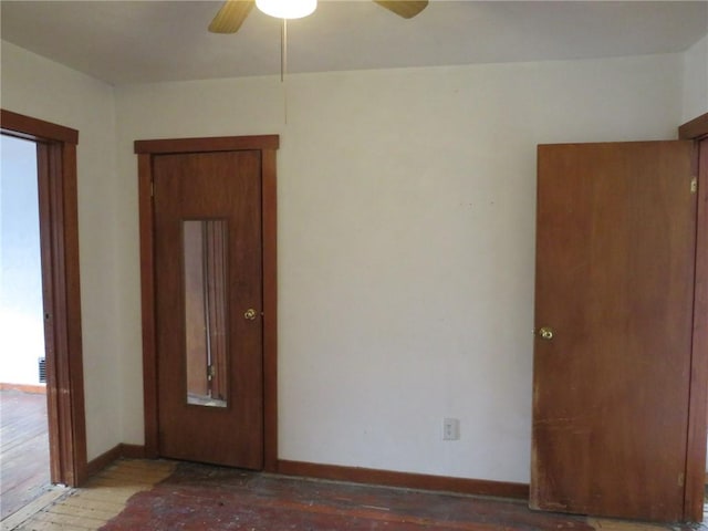 spare room featuring hardwood / wood-style flooring, ceiling fan, baseboards, and a wealth of natural light