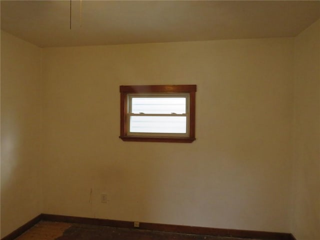 unfurnished room featuring baseboards