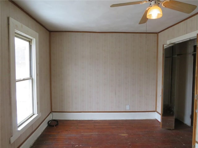 spare room featuring hardwood / wood-style flooring, baseboards, and wallpapered walls