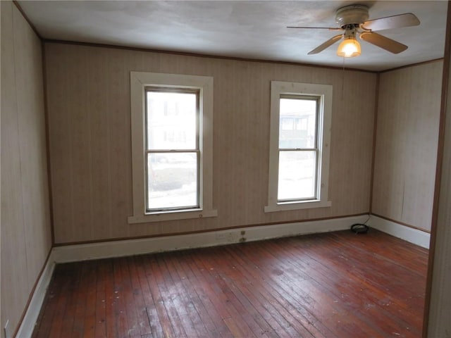 unfurnished room with ceiling fan, wood-type flooring, and baseboards