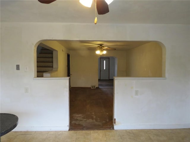 unfurnished room with ceiling fan, visible vents, and baseboards