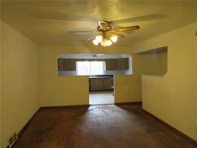 spare room featuring visible vents, ceiling fan, and baseboards