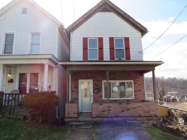 view of front of house featuring a porch and brick siding