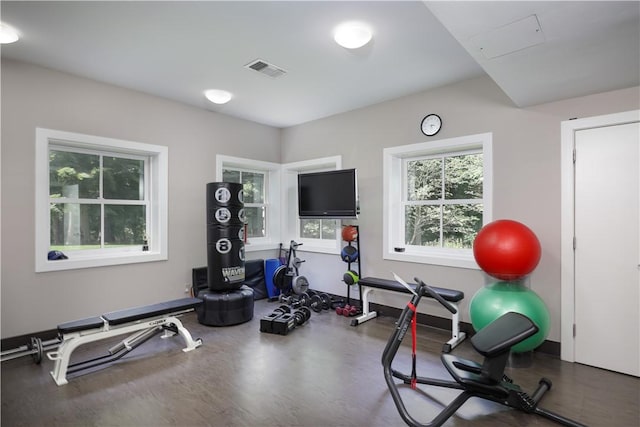 workout area featuring visible vents and wood finished floors