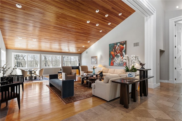 living room with high vaulted ceiling, wood ceiling, visible vents, and baseboards