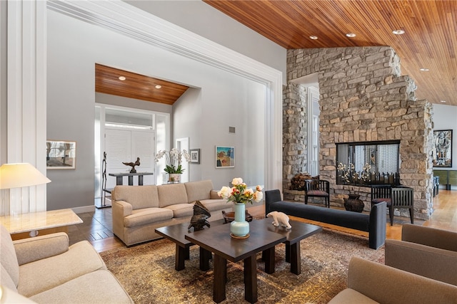 living room with lofted ceiling, wooden ceiling, a fireplace, and recessed lighting