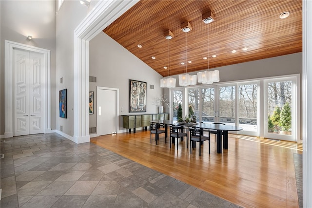 dining area with high vaulted ceiling, wooden ceiling, wood finished floors, visible vents, and baseboards