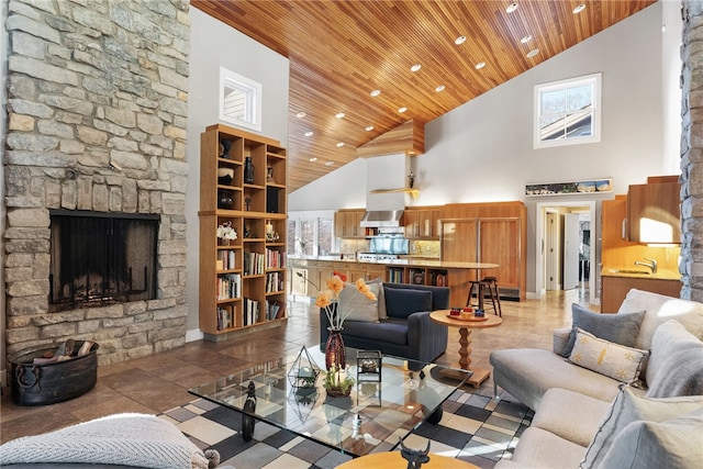 living area featuring high vaulted ceiling, recessed lighting, wooden ceiling, and a fireplace