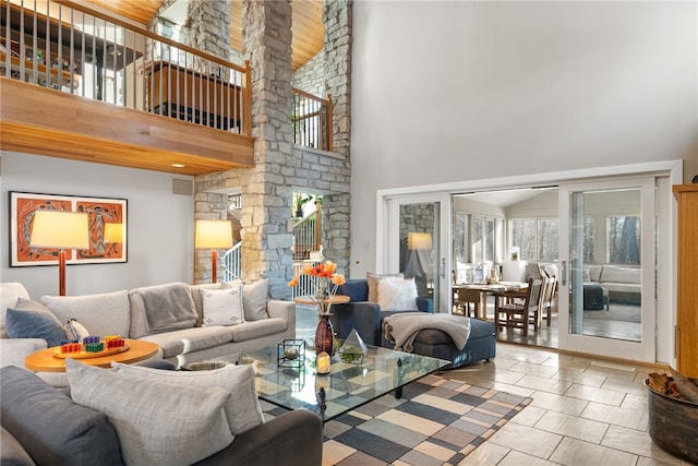 living area with french doors, visible vents, and a high ceiling