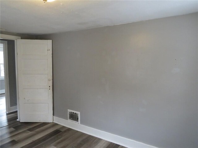 empty room with dark hardwood / wood-style floors