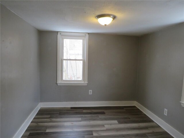 spare room with dark hardwood / wood-style flooring