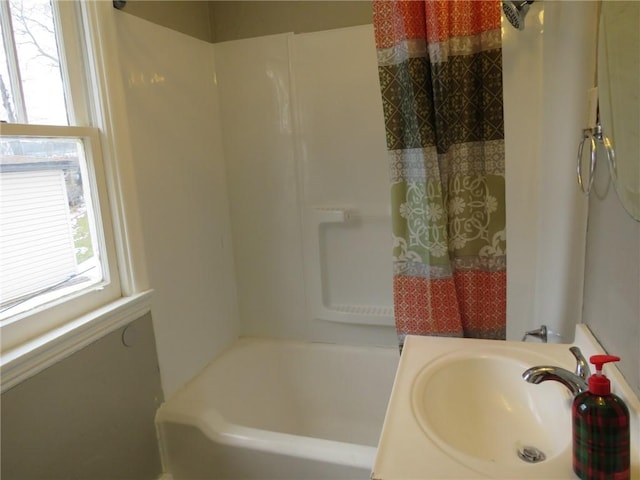 full bathroom featuring a sink, shower / bath combination with curtain, and a wealth of natural light