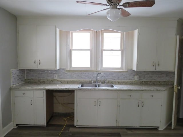 kitchen featuring sink and white cabinets