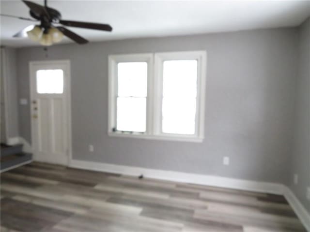 entryway with ceiling fan, wood finished floors, and baseboards