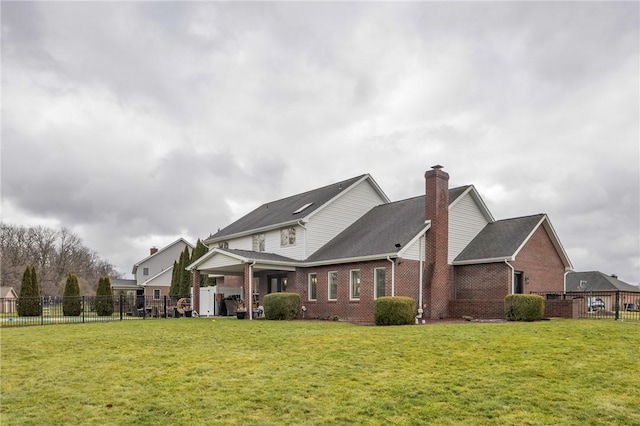 rear view of house with a yard