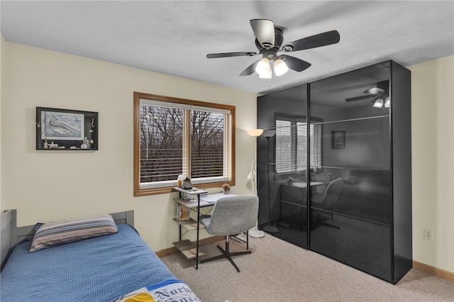 carpeted bedroom featuring ceiling fan and a closet