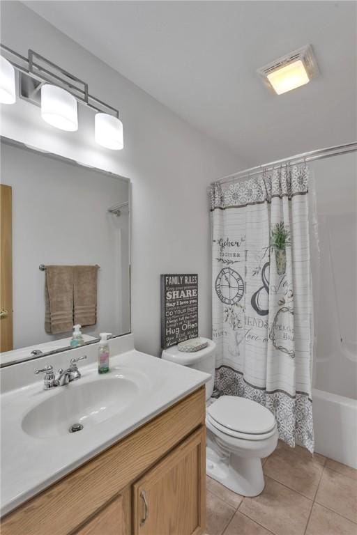 full bathroom featuring tile patterned flooring, toilet, vanity, and shower / bath combo with shower curtain