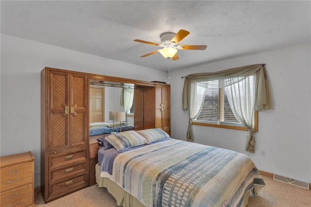 bedroom with light colored carpet and ceiling fan