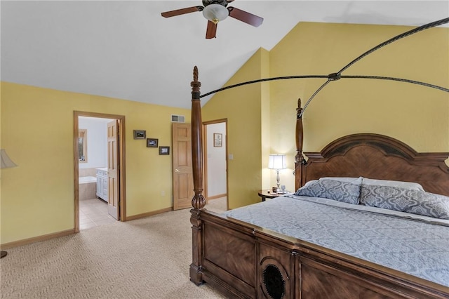 bedroom featuring ceiling fan, connected bathroom, vaulted ceiling, and light carpet