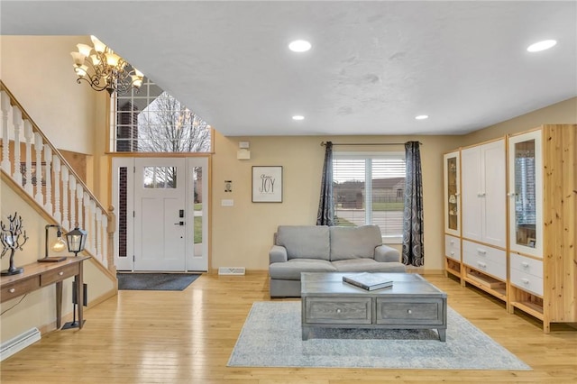 living room featuring a chandelier and light hardwood / wood-style floors