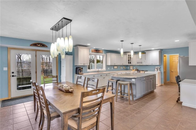 tiled dining space featuring sink