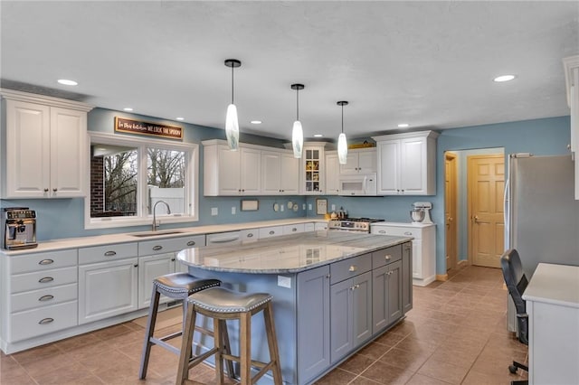 kitchen featuring appliances with stainless steel finishes, sink, and white cabinets