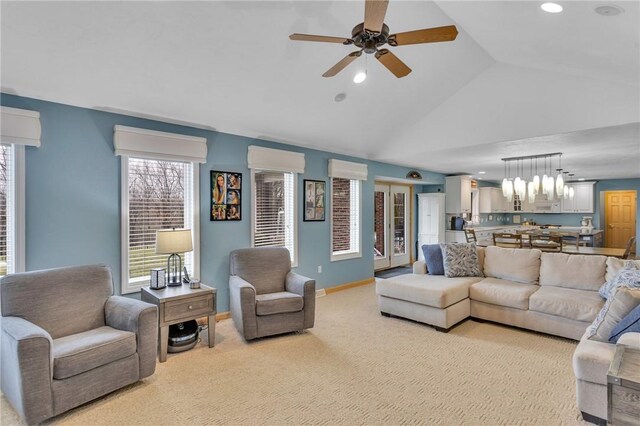 living room with ceiling fan, a wall mounted air conditioner, vaulted ceiling, and light carpet