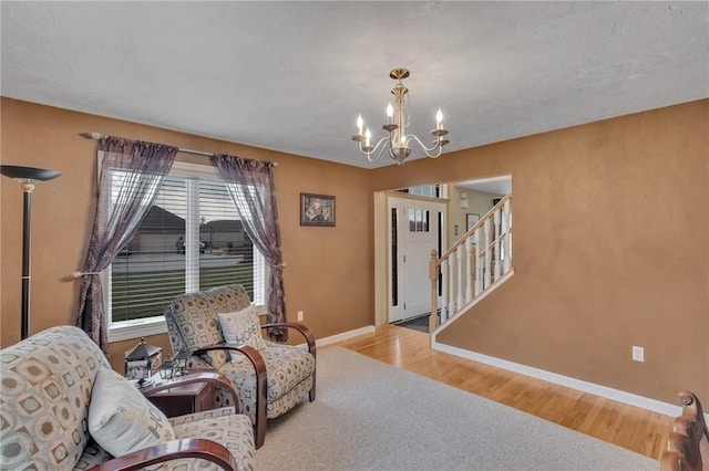 living area with a notable chandelier and light hardwood / wood-style floors