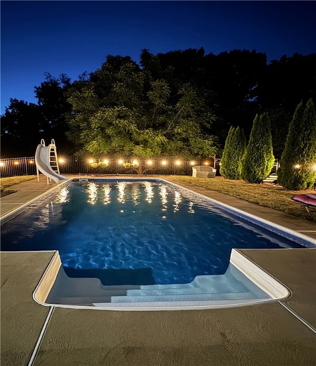 pool at twilight with a water slide