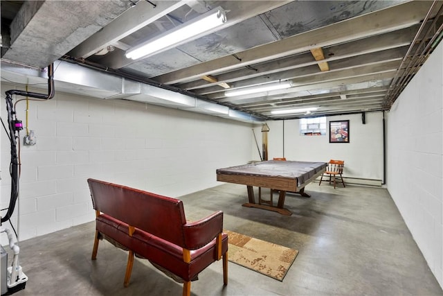 recreation room with billiards, a baseboard radiator, and concrete flooring