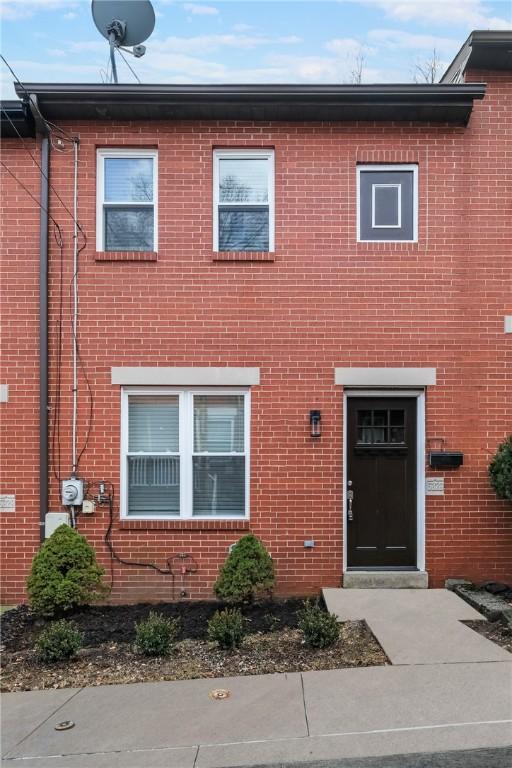 townhome / multi-family property featuring brick siding