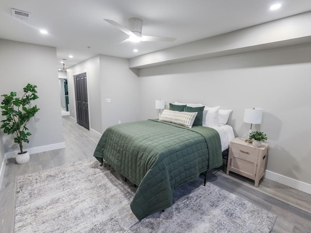 bedroom with a closet, ceiling fan, and light wood-type flooring