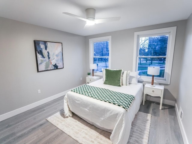 bedroom featuring wood-type flooring and ceiling fan