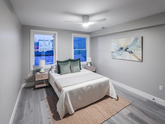 bedroom with ceiling fan and hardwood / wood-style floors