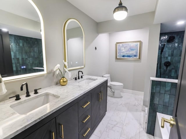 bathroom featuring vanity, tiled shower, and toilet