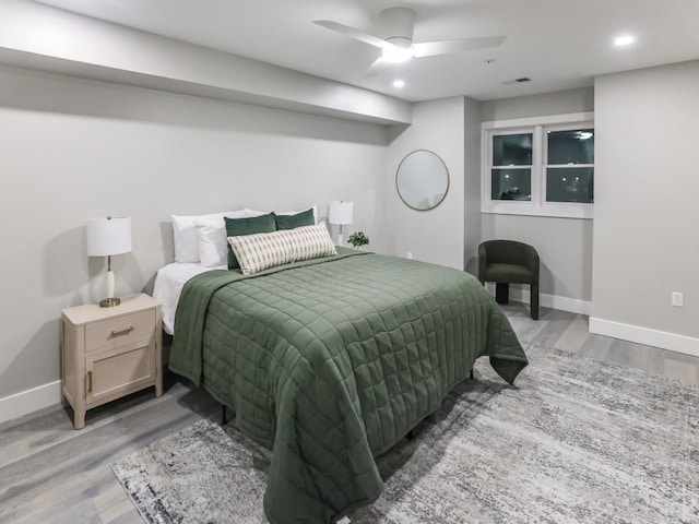 bedroom with light hardwood / wood-style flooring and ceiling fan