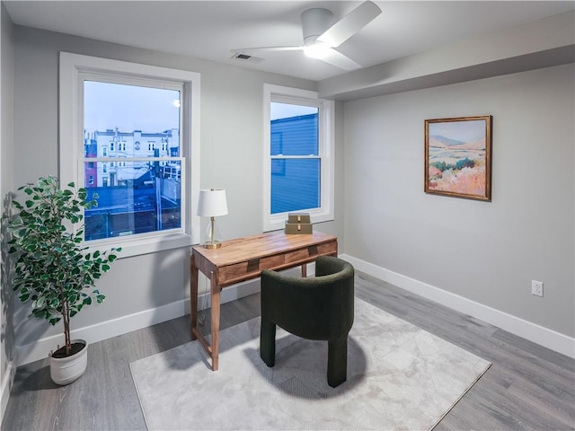 home office with hardwood / wood-style flooring and ceiling fan