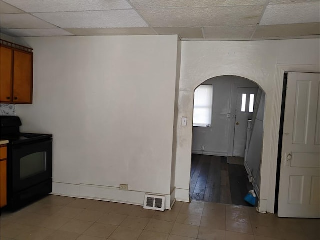 kitchen with a drop ceiling and black / electric stove