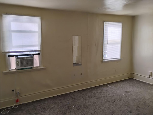 unfurnished room featuring dark carpet