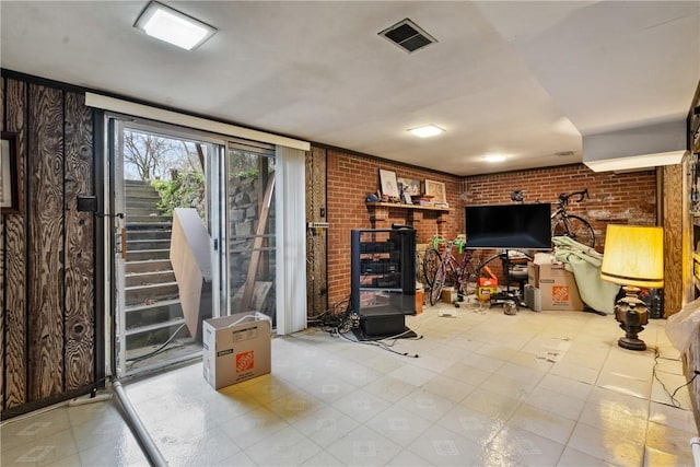 living room featuring brick wall