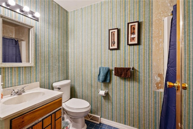 bathroom featuring vanity, tile patterned floors, and toilet