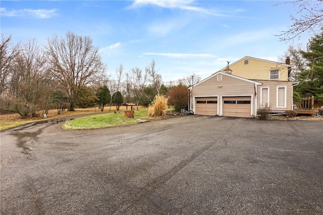 view of side of home featuring a garage